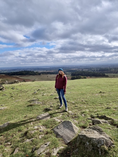 A young woman standing on a hillside